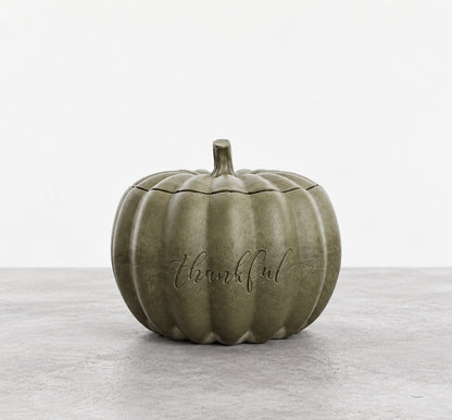 Closed Thankful pumpkin candle in smoky olive green concrete, with an engraved front and a matching ribbed lid topped with a stem.