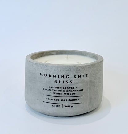 Morning Knit Bliss soy candle in gray concrete vessel on white background