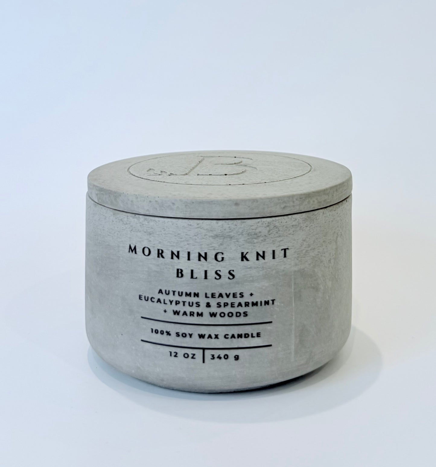 Morning Knit Bliss soy candle with lid in gray concrete vessel, autumn leaves eucalyptus spearmint warm woods scented candle