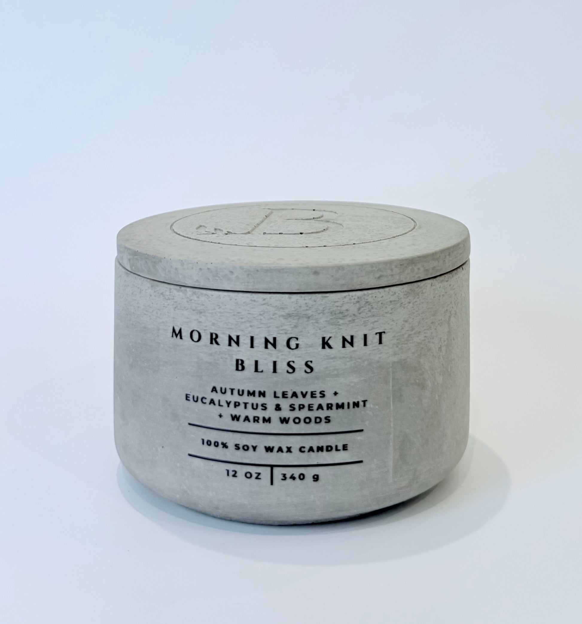 Morning Knit Bliss soy candle with lid in gray concrete vessel, autumn leaves eucalyptus spearmint warm woods scented candle
