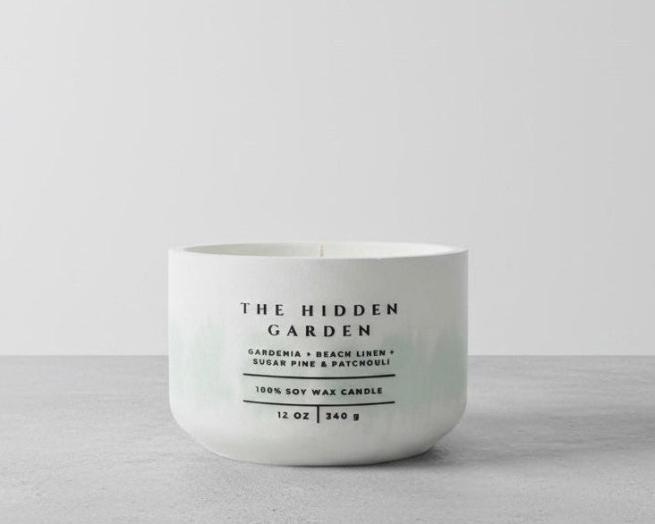 The Hidden Garden Christian Soy Candle with Gardenia, Beach Linen, Sugar Pine, and Patchouli in a Handcrafted Concrete Vessel.