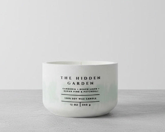 The Hidden Garden Christian Soy Candle with Gardenia, Beach Linen, Sugar Pine, and Patchouli in a Handcrafted Concrete Vessel.