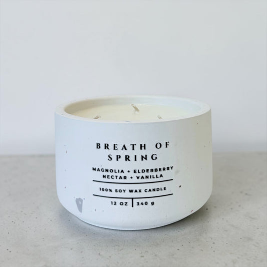 Breath of Spring soy candle in white concrete vessel with magnolia elderberry nectar and vanilla scent