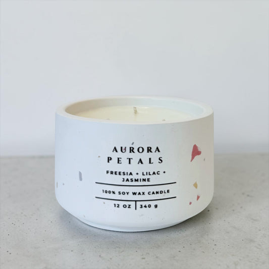 Aurora Petals soy candle in white terrazzo concrete vessel with floral scent on gray background