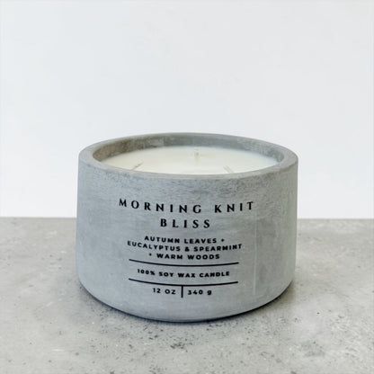 Morning Knit Bliss soy candle in gray concrete vessel with eucalyptus spearmint and warm woods scent