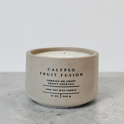 Calypso Fruit Fusion soy candle in beige concrete vessel with tropical fruity scent on gray background