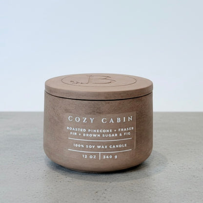 Cozy Cabin luxury soy wax candle with matching concrete lid, featuring roasted pinecone, Fraser fir, and brown sugar fig fragrance. Christian gift by Boswellia Candle Co.