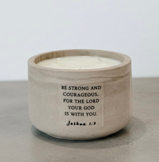 Christian soy wax candle featuring Joshua 1:9 Bible verse, “Be strong and courageous, for the Lord your God is with you,” handcrafted in a concrete vessel. Faith-inspired gift by Boswellia Candle Co.