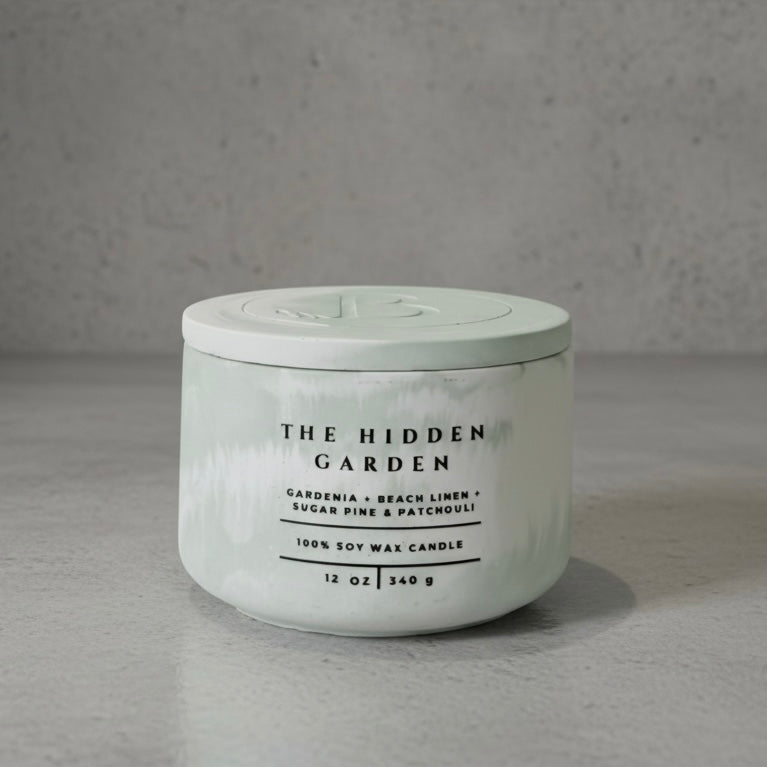 The Hidden Garden Christian Soy Candle with Gardenia, Beach Linen, Sugar Pine, and Patchouli in a Handcrafted Concrete Vessel with Lid.