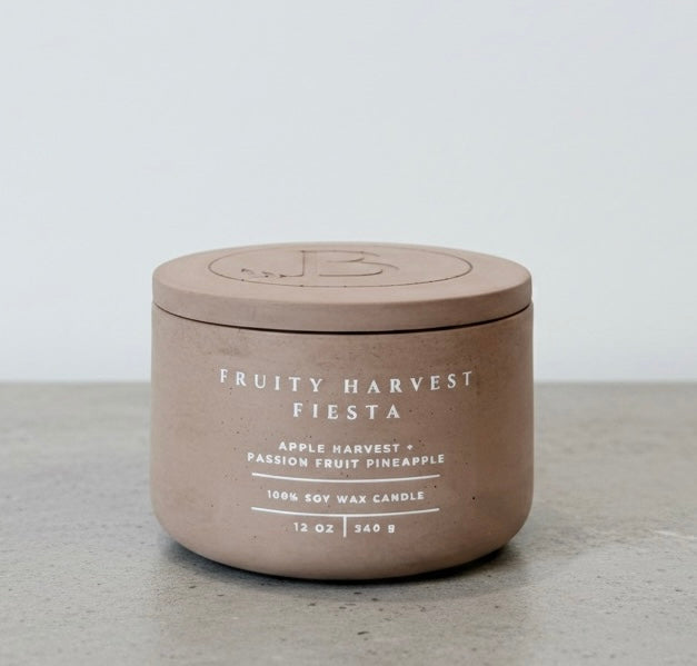 Fruity Harvest Fiesta luxury soy wax candle with matching concrete lid, handcrafted vessel featuring apple harvest, passion fruit, and pineapple fragrance notes. Faith-inspired gift by Boswellia Candle Co.