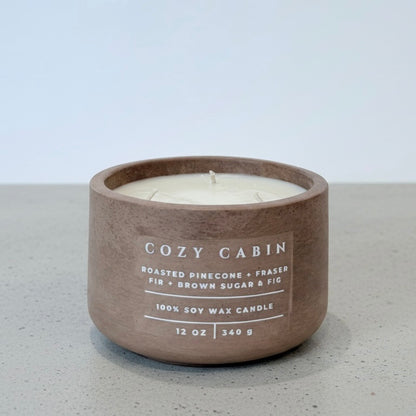 Cozy Cabin Christian soy wax candle with roasted pinecone, Fraser fir, and brown sugar fig fragrance, handcrafted in a concrete vessel. Faith-inspired gift by Boswellia Candle Co.