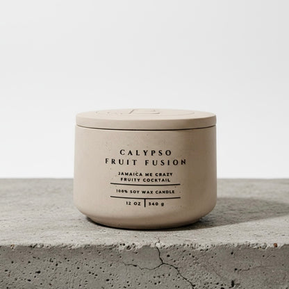 Calypso Fruit Fusion luxury tropical soy wax candle with matching concrete lid, handcrafted concrete vessel featuring Jamaica Me Crazy fragrance. Faith-inspired gift by Boswellia Candle Co.