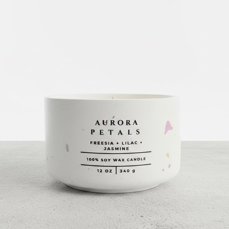 Aurora Petals floral soy wax candle in a handmade white concrete vessel, scented with freesia, lilac, and jasmine. Luxury Christian candle and faith-inspired gift by Boswellia Candle Co.
