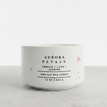 Aurora Petals floral soy wax candle in a handmade white concrete vessel, scented with freesia, lilac, and jasmine. Luxury Christian candle and faith-inspired gift by Boswellia Candle Co.