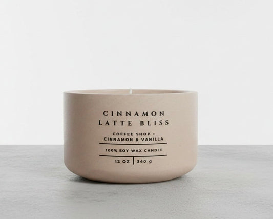 Cinnamon Latte Bliss soy candle in beige concrete vessel with coffee, cinnamon and vanilla scent on gray background