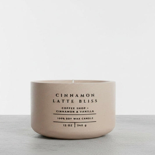 Cinnamon Latte Bliss soy candle in beige concrete vessel with coffee, cinnamon and vanilla scent on gray background