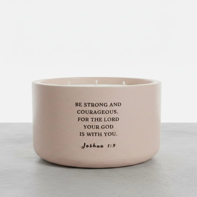 Christian soy wax candle featuring Joshua 1:9 Bible verse, “Be strong and courageous, for the Lord your God is with you,” handcrafted in a concrete vessel. Faith-inspired gift by Boswellia Candle Co.