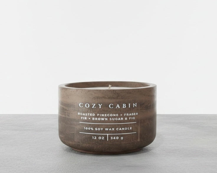 Cozy Cabin Christian soy wax candle with roasted pinecone, Fraser fir, and brown sugar fig fragrance, handcrafted in a concrete vessel. Faith-inspired gift by Boswellia Candle Co.