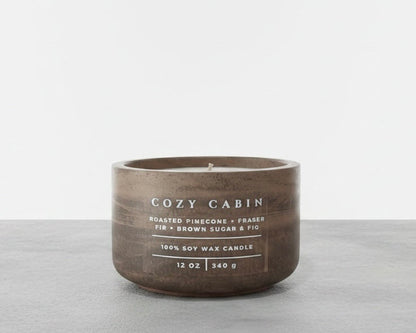 Cozy Cabin Christian soy wax candle with roasted pinecone, Fraser fir, and brown sugar fig fragrance, handcrafted in a concrete vessel. Faith-inspired gift by Boswellia Candle Co.