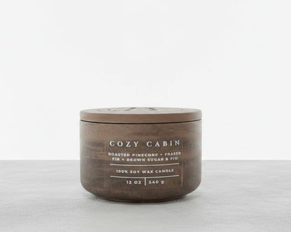 Cozy Cabin luxury soy wax candle with matching concrete lid, featuring roasted pinecone, Fraser fir, and brown sugar fig fragrance. Christian gift by Boswellia Candle Co.
